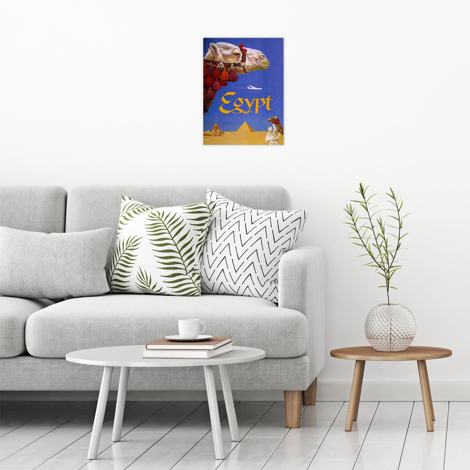 A contemporary modern room view showing a medium size metal art poster display plate with printed design of a Egypt Fly TWA (1960) vintage poster by David Klein