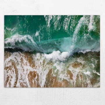 Wave crashing on the sandy beach at Balboa Island