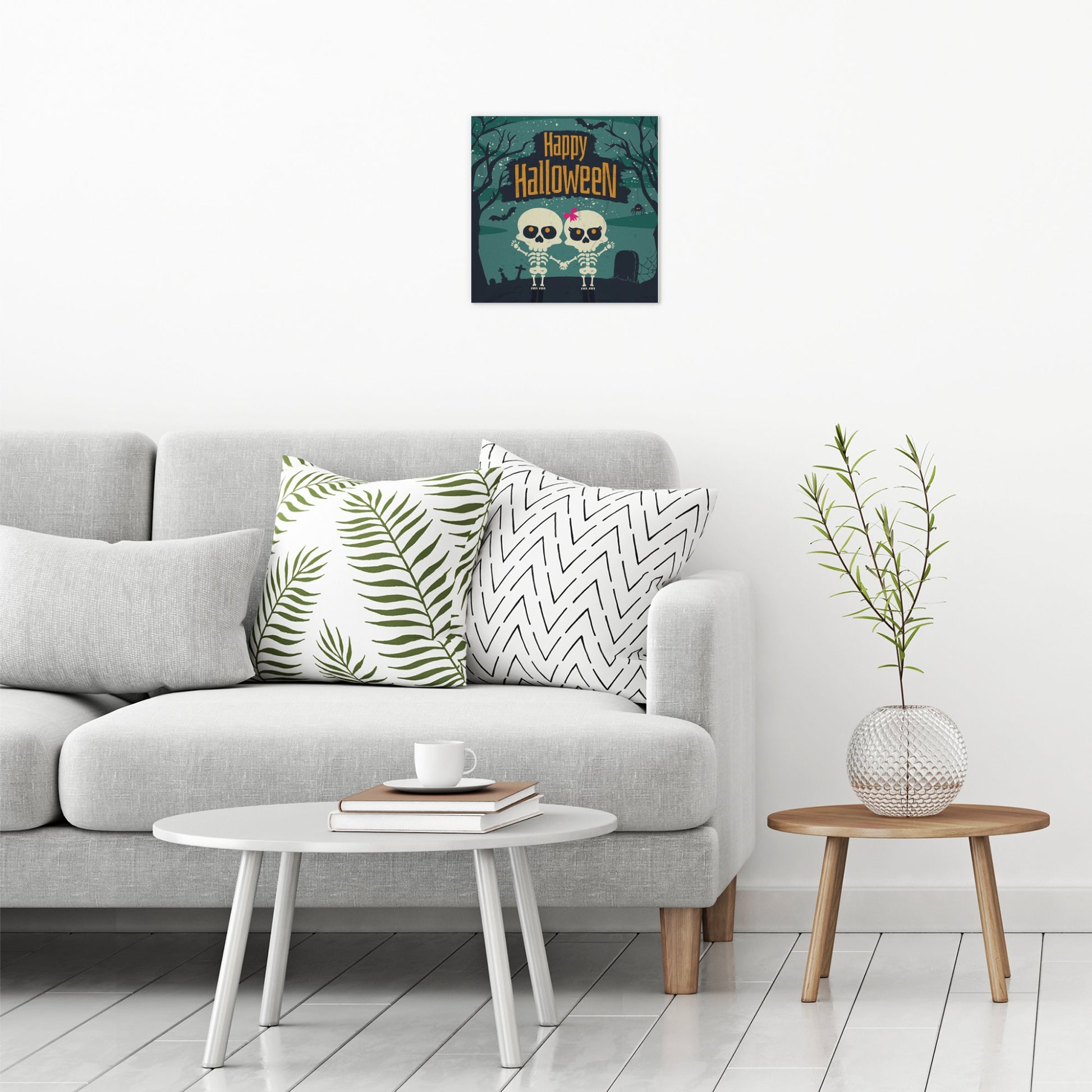 A contemporary modern room view showing a medium size metal art poster display plate with printed design of a Happy Halloween Cute Skeletons